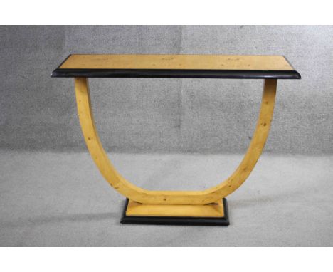 An Art Deco style bird's eye maple and ebonised console table on shaped support resting on platform base. H.90 W.117 D.40 cm 