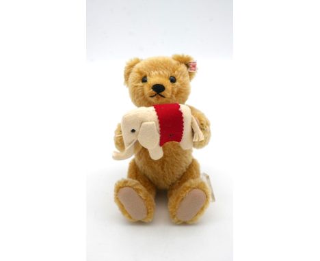 A Steiff 'Teddys Elephant', blonde, boxed with Steiff gold button to the ear. H.25cm (bear) 