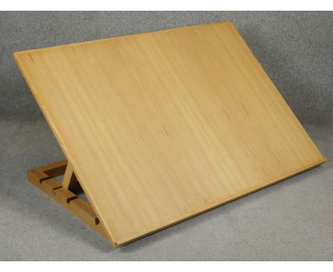 A modern light oak table top adjustable draughtsman's or architects's drafting table. H.84 W.120cm 