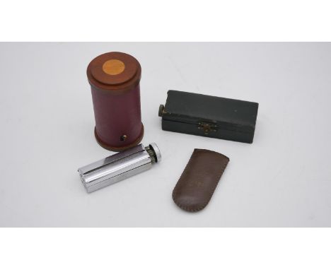 A cased pistol table lighter along with a Rexcell cigarette rolling machine, a WWII convoy brass No.5 lighter with leather po