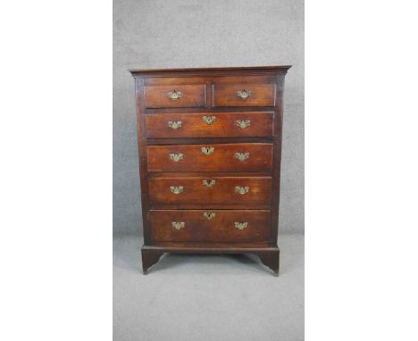 A Georgian country oak tall chest of two short above four long graduating drawers on bracket feet. H.140 W.100 D.60cm 