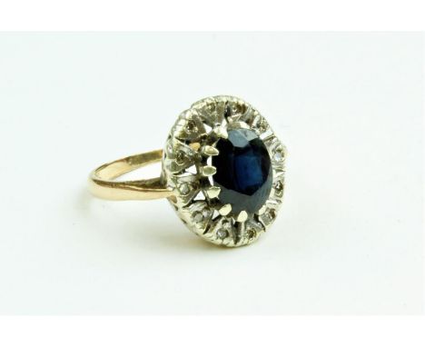 An attractive Ladies oval shaped Ring, with large centre sapphire surrounded by small inset diamonds, mounted on gold band, s