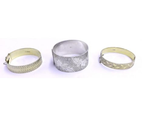 Two silver gilt bangles; together with a silver bangle, 4.5oz approx