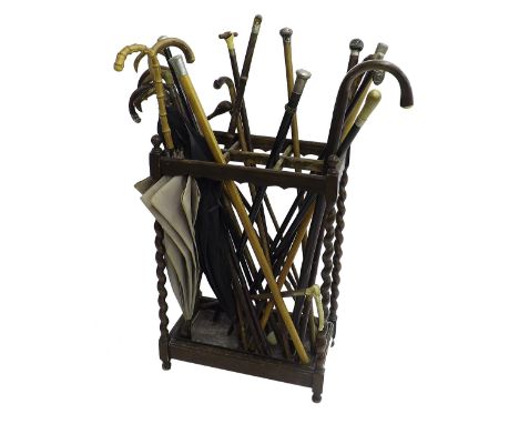 Barley twist sectional stick stand inset with a large selection of various sticks, canes, umbrellas etc (24 approx)