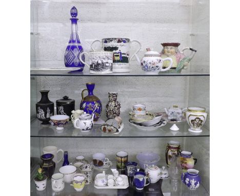 Three shelves of 19th century and later porcelain and ceramics to include jugs, blue overlaid glass decanter, vases, coffee c