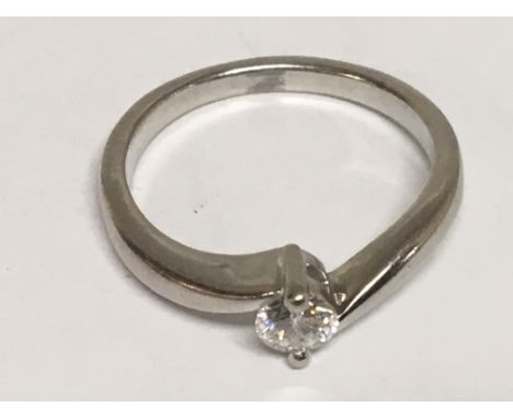 A Platinum (900) modern design ring set with a solitaire brilliant cut diamond. Ring size K.