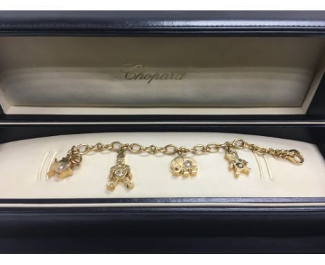 A heavy 18ct gold Chopard charm bracelet set with diamonds in original box, approx 48.2g.