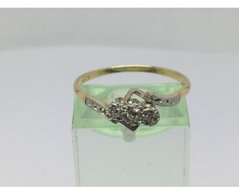 A circa 1930s 18ct gold and platinum three stone diamond ring, approx 2.5g and approx size R.