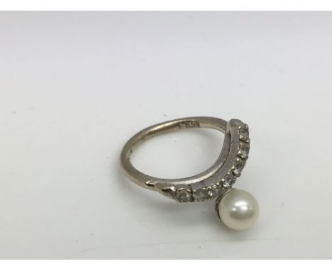 A white gold pearl and stone set ring. (E).