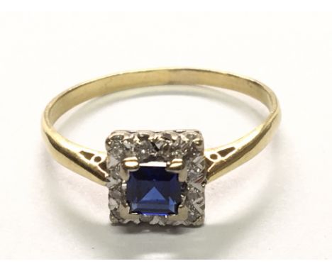 An 18carat gold ring set with a blue sapphire and diamonds in a square setting. Ring size R.