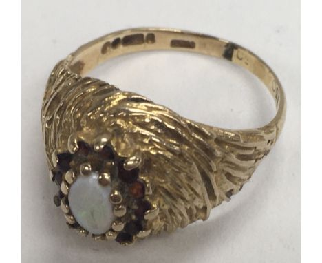 A 1980s 9ct gold opal and garnet ring (Approx 3g) ring size M.5.