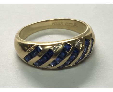 An 18carat gold ring set with a pattern of blue sapphire and diamonds. ring size M.