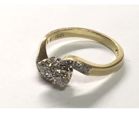 An 18carat gold ring diamond cross over with further diamonds to the shank. ring size K.