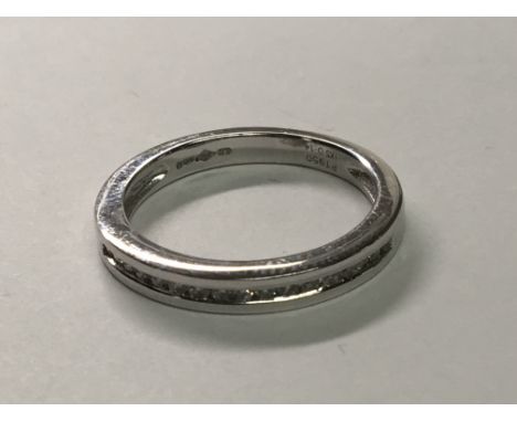 A Platinum half hoop eternity ring set with a row of brilliant cut diamonds. ring size M.