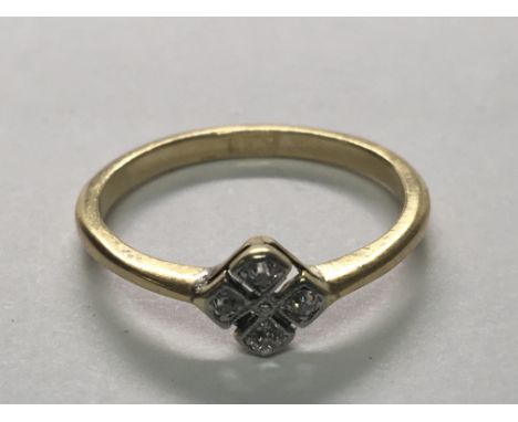 An 18carat gold ring set with a pattern of four diamonds. Ring size N.