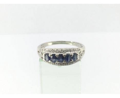 A ladies 9ct white gold ring set with diamonds and five sapphires, approx 3.6g and approx size S.