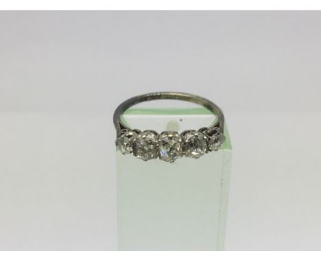 A ring, possibly platinum, set with five old cut or cushion cut stones, approx 2.4g and approx size M-N.