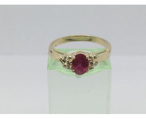 A 14ct gold ring set with a synthetic ruby and ten small diamonds, approx 3g and approx size P-Q.