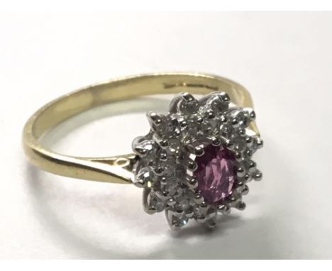 An 18 carat gold ruby and diamond cluster ring size O.