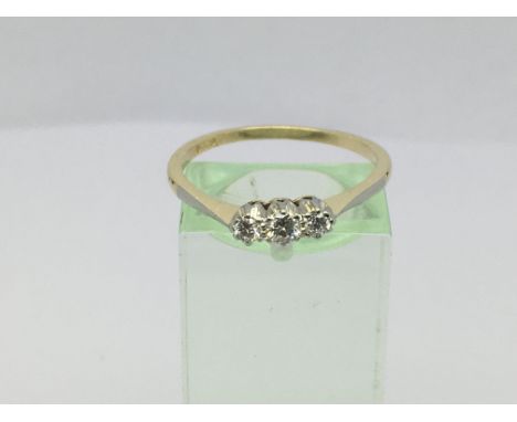 A ladies 18ct gold three stone diamond ring, approx.15ct, approx 2.6g and approx size S.