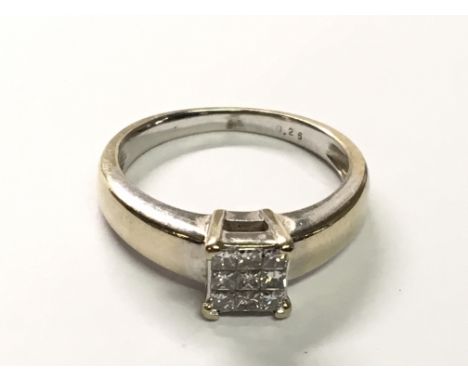 An 18carat gold ring set with a square pattern of princess cut diamonds. Ring Size K.