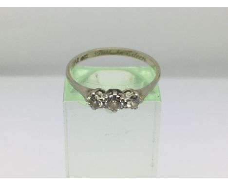 An 18ct white gold and three stone diamond ring, approx size Q-R and approx 2g.