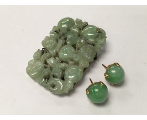 A pair of 18ct gold mounted Apple green jade studs plus a silver mounted carved jade brooch. (A/F).