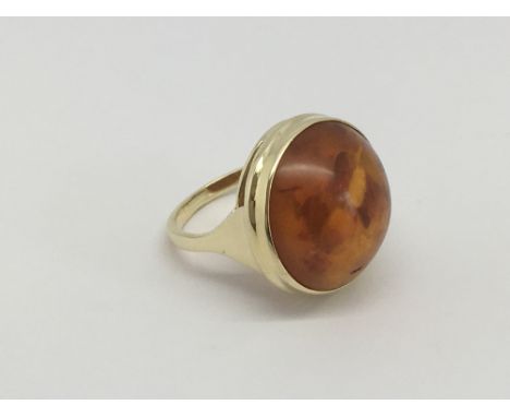 A 14ct gold ring set with cabochon amber, approx 8g and approx size P-Q.