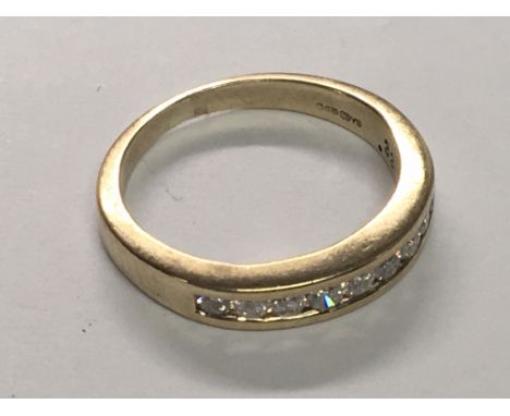 A 9carat gold half hoop eternity ring set with a row of brilliant cut diamonds. 0.33 of a carat weight Ring size I