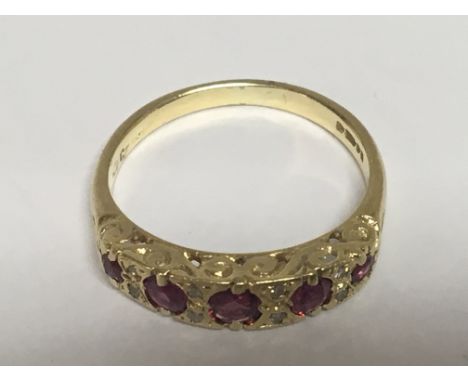 An 18carat gold ring set with a row of RubyÕs and small diamonds ring size K-L