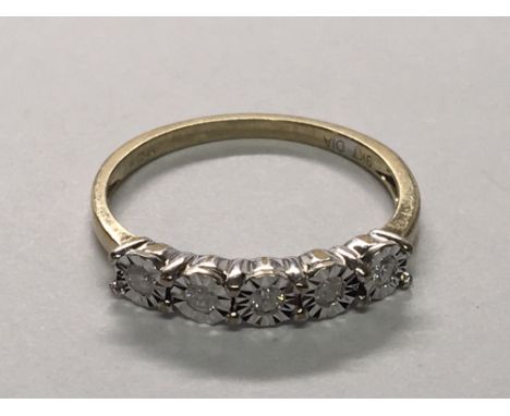 A 9carat gold ring illusion set with a row of six diamonds. Ring size M.