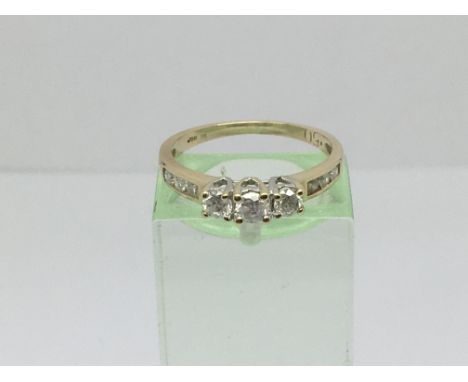 A 9ct gold ring set with three diamonds and further diamonds to the shoulders, approx.50ct, approx 1.6g and approx size K-L.