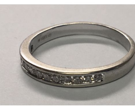 An 18carat white gold half hoop eternity ring set with a row of brilliant cut diamonds. ring size N.