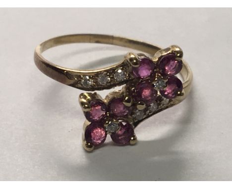 A 9carat gold ring set with RubyÕs and diamonds ring Size N.