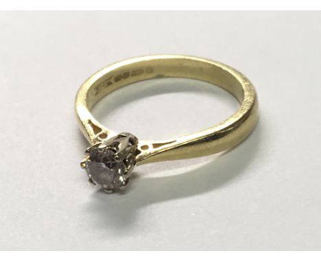 An 18carat gold ring set with a brilliant cut solitaire diamond ring size K.