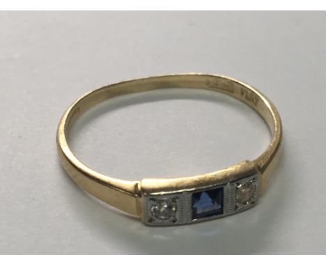 An 18carat gold Ring Early 20th Century set with a blue sapphire flanked by diamonds. ring size N.