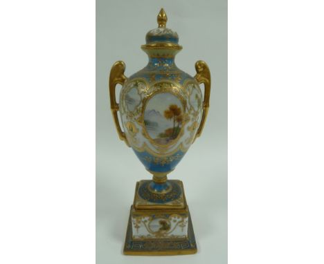 EARLY TWENTIETH CENTURY NORITAKE PORCELAIN TWO HANDLED PEDESTAL VASE AND COVER, of typical form with moulded gilt handles and