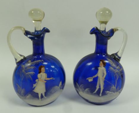 PAIR OF NINETEENTH CENTURY 'MARY GREGORY' BLUE GLASS CLARET JUGS, of flask form with loop handles, wavy rims and clear stoppe