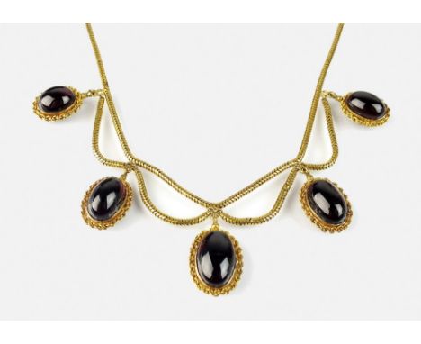 A Victorian garnet set locket fringe necklace, designed as five graduated oval cabochon garnets, each collet set in yellow me