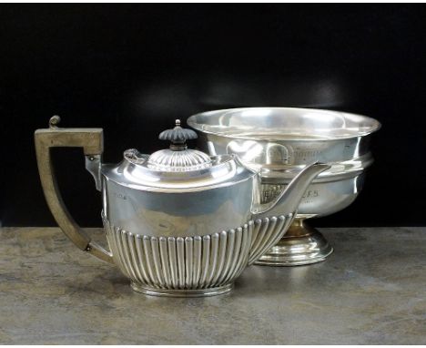 An Edwardian silver teapot, makers mark rubbed, Birmingham 1909, of oval half reeded form with ebonised handle and finial, 14