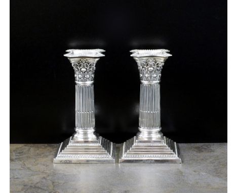 A pair of short silver Corinthian column candlesticks, Harrison Brothers & Howson, Sheffield 1907 & 1908, each with removable