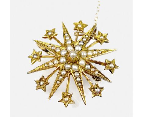 An early 20th century 9ct gold seed pearl set brooch/pendant, of starburst design, with attached safety chain, hallmarked Che