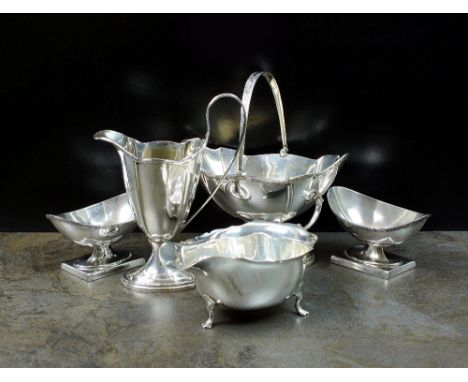 A silver swing handled sugar bowl and helmet cream jug, GW & S, Birmingham 1907, together with a silver sauce boat, Birmingha