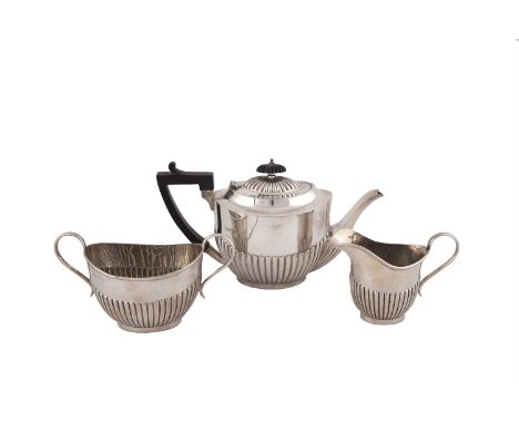 AN IRISH THREE PIECE SILVER TEA SERVICE, Dublin 1933, mark of Hopkins and Hopkins, comprising teapot, two handled sugar bowl 