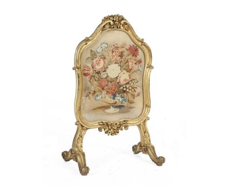 A FRENCH GILTWOOD AND GESSO CARTOUCHE SHAPED FIRE SCREEN, surmounted with foliage and scroll work, the tapestry panel depicti