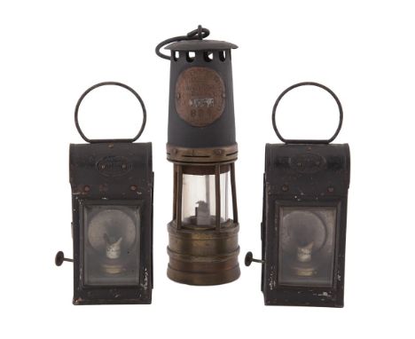 AN ACKROYD AND BEST LTD BLACKENED METAL, COPPER AND BRASS CYLINDRICAL MINER'S LAMP, stamped with miner's reference number; to