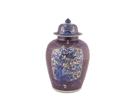 A CHINESE POLYCHROME PORCELAIN JAR AND COVER, 19th century, the domed cover with painted finial and body with clobbered decor