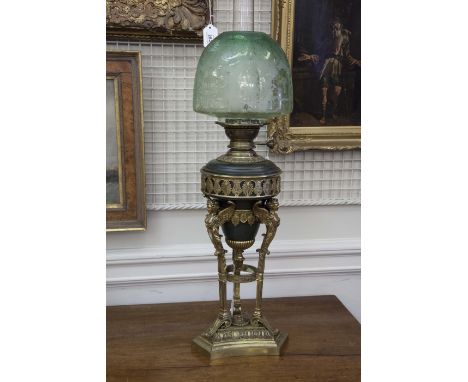 A FRENCH EMPIRE STYLE OIL LAMP, with green glass acid etched shade, the reservoir with applied pierced gilt metal decoration 