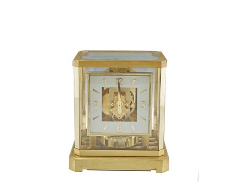 A JAEGER LE COULTRE ATMOS MANTLE CLOCK, in fitted case, with clear glass top and side panels, angled corners and squared dial