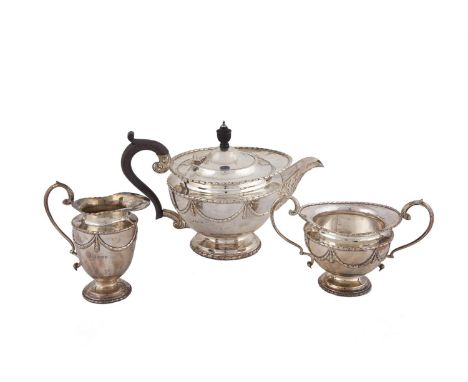 A SILVER THREE PIECE TEA SERVICEE IN THE NEOCLASSICAL TASTE, Sheffield 1918, makers mark rubbed, chased and engraved with bel